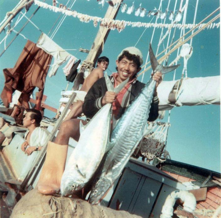 Person showing two fish. 